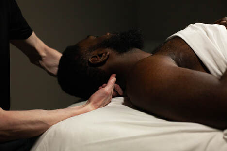 Premium Photo  Highangle view of caucasian male masseur massaging back of  muscular sportsman lying on massage table